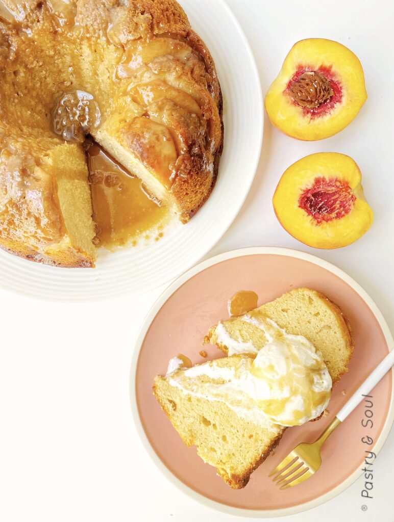 rum cake on a pink and white plates with a peach cut in half 