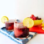 Drink in a glass cup on a blue dish towel