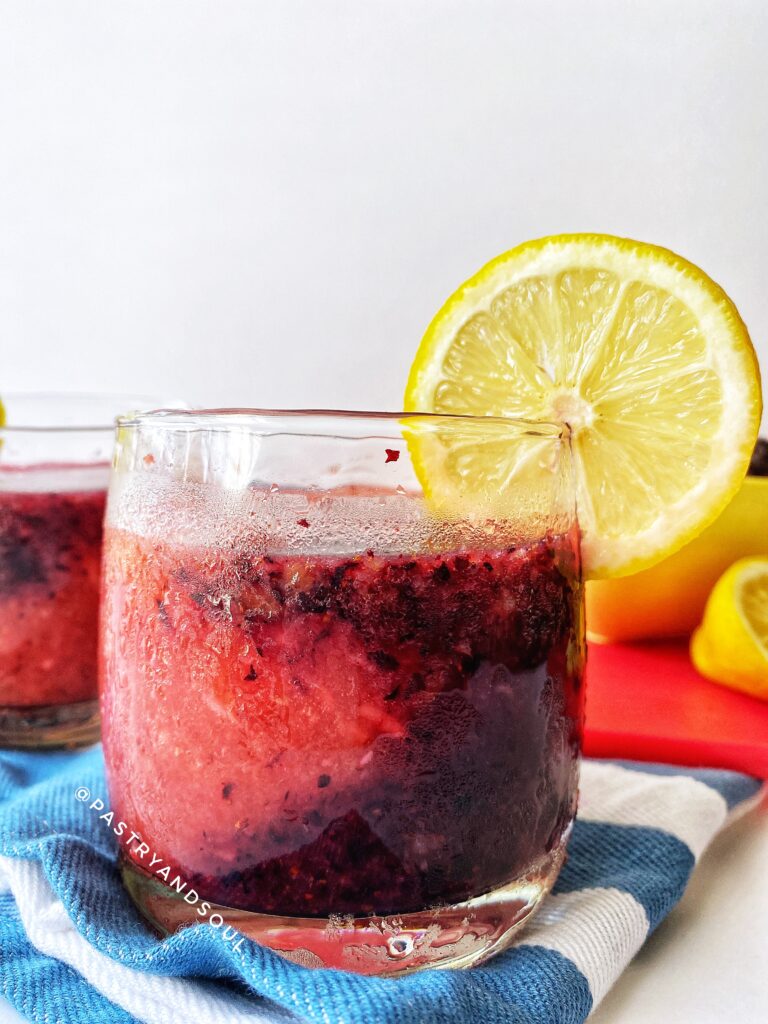 Slushy in a glass cup on a blue and white dish towel