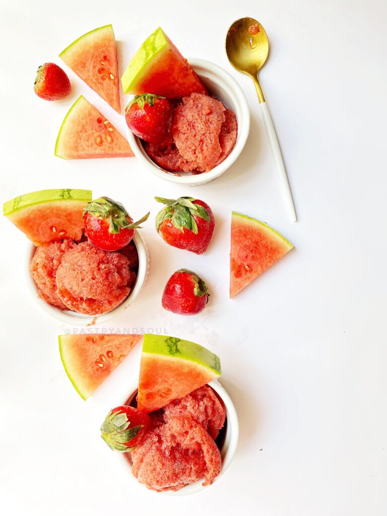 watermelon-strawberry and basil sorbet in a white ramekin with a white background.