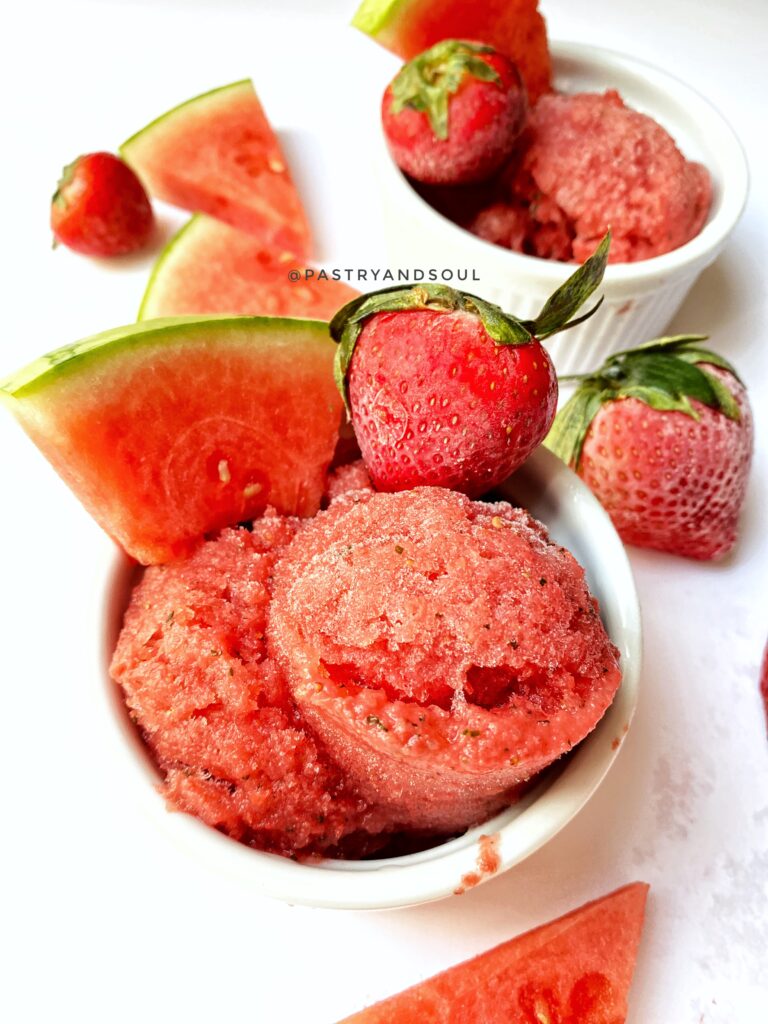 watermelon-strawberry and basil sorbet in a white ramekin with a white background.